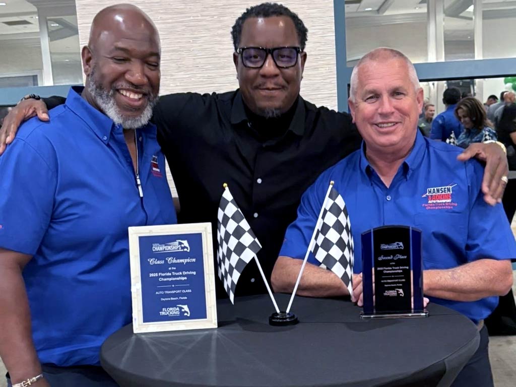Two Hansen & Adkins team members holding their awards at the FTA Truck Driving Championship 2025