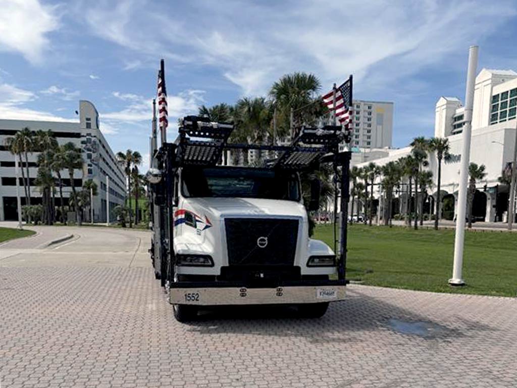 Hansen & Adkins truck on display with American flags at the Florida Trucking Association Truck Driving Championship 2025